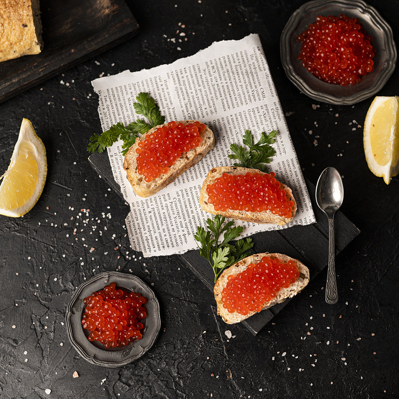 Premium salmon roe (ikura) stored in a glass container with an airtight lid in the refrigerator to preserve freshness and texture