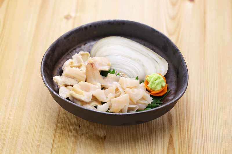 Fresh geoduck clam with its long siphon on crushed ice, ready for sashimi or stir-fry, sourced from the Pacific Northwest