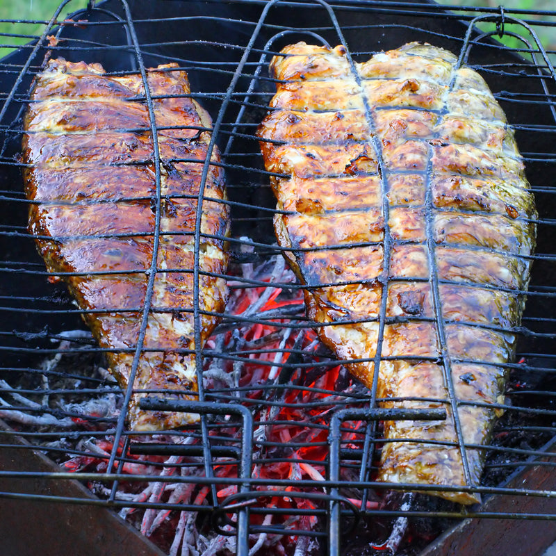 Elegant spread of premium seafood including fresh fish fillets, caviar, and king crab on a rustic wooden surface