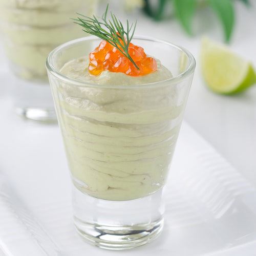 Elegant cocktail glasses with colorful edible caviar pearls floating in champagne and citrus cocktails on a bar counter