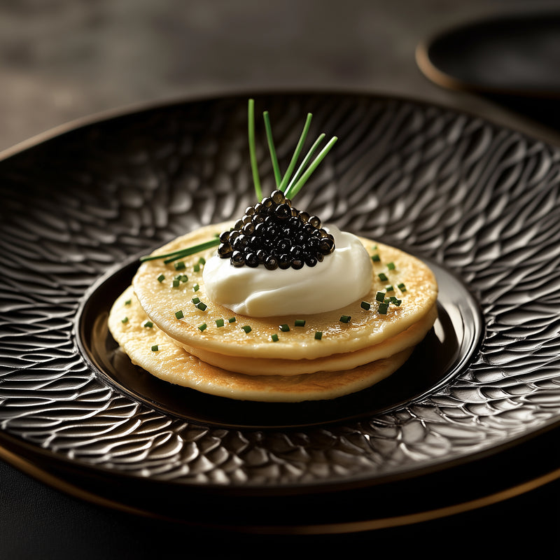 Ossetra sturgeon caviar pearls spooned onto buttered toast points garnished with fresh dill