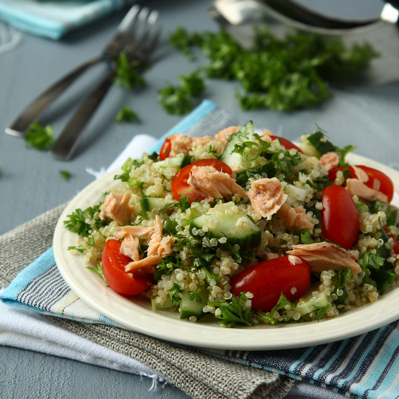 Curried salmon salad with mixed greens, cherry tomatoes, and creamy curry dressing