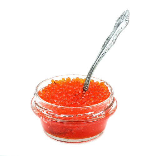 Fresh salmon roe eggs being separated from the sac membrane over a fine mesh sieve