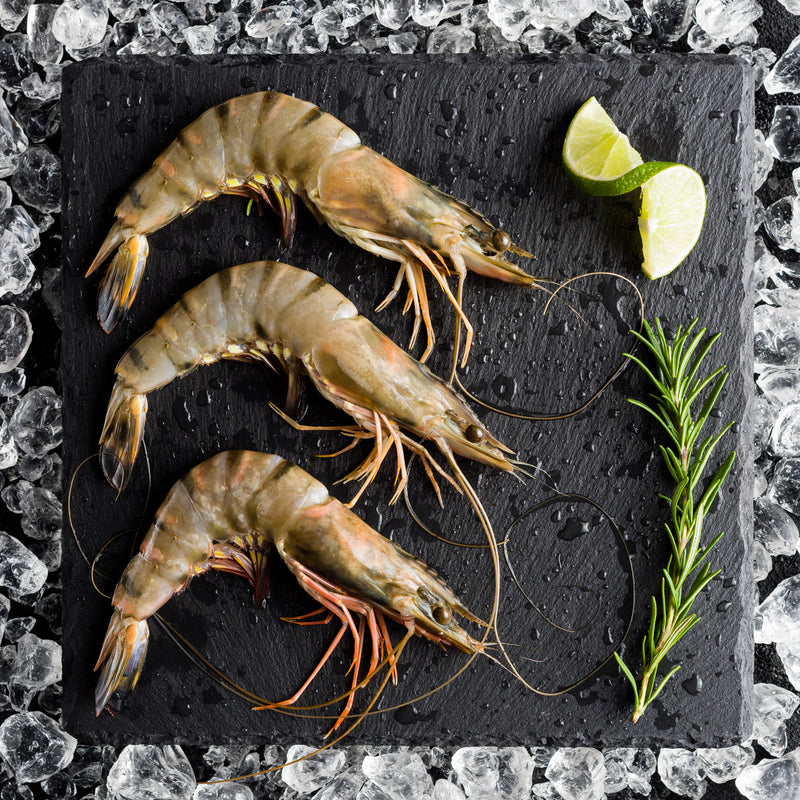 A lavish spread of international seafood dishes including caviar, king crab legs, and sushi on a dining table