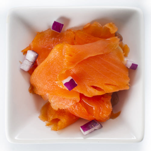 Three sockeye salmon products displayed together: smoked salmon slices, canned salmon, and fresh fillets