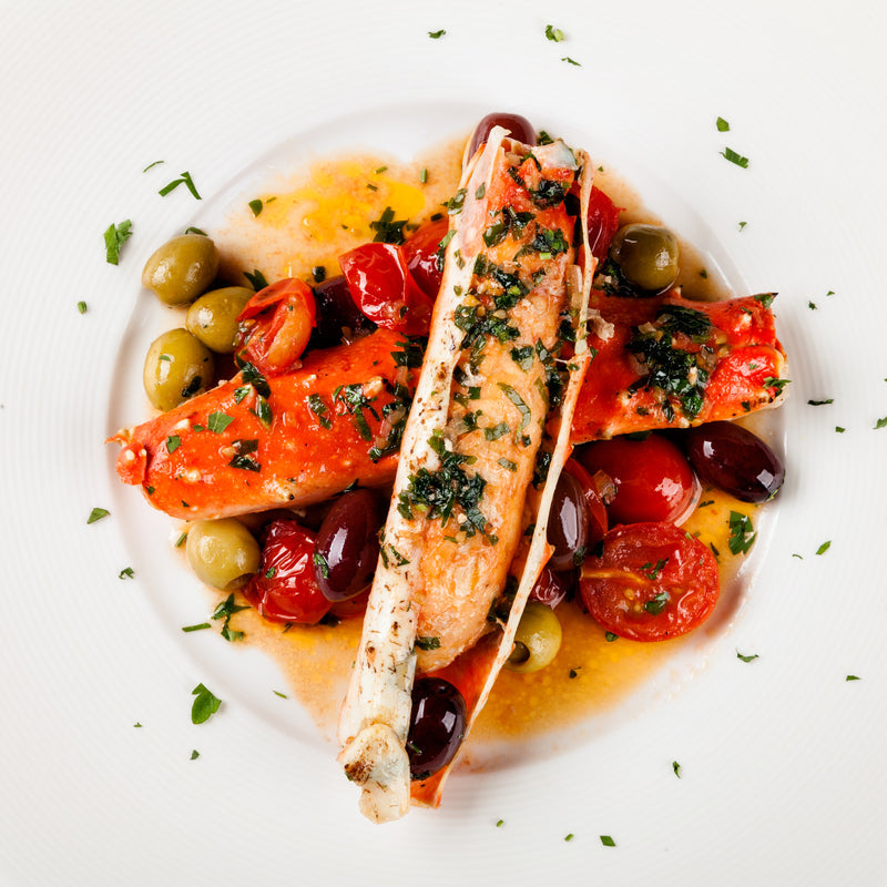 King Crab Española — jumbo Alaskan king crab legs served with a rich Spanish-style sauce