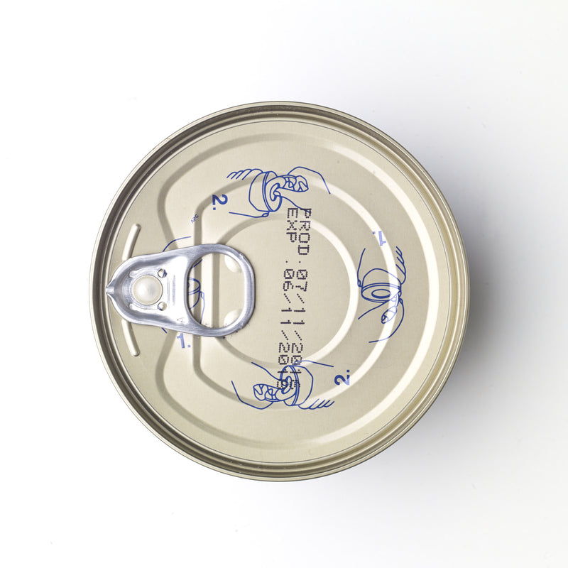Side-by-side comparison of smoked tuna fillet and canned tuna on a wooden board