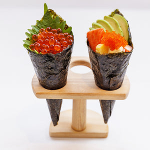 Handmade sushi rolls topped with glistening salmon roe