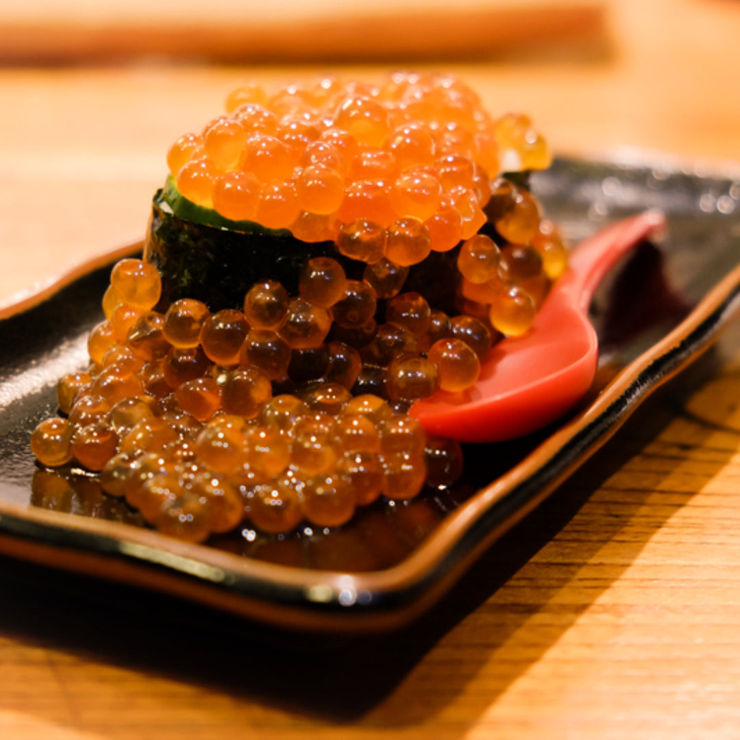 Salmon Ikura roe served on sushi rice