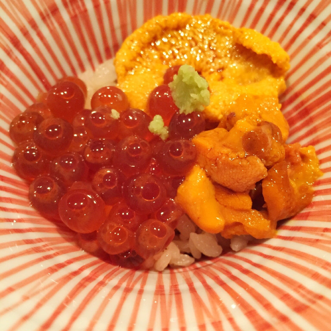 Bowl of vibrant Ikura (salmon roe) showcasing its rich orange color and delicate texture, symbolizing its transformation from traditional food to gourmet delicacy