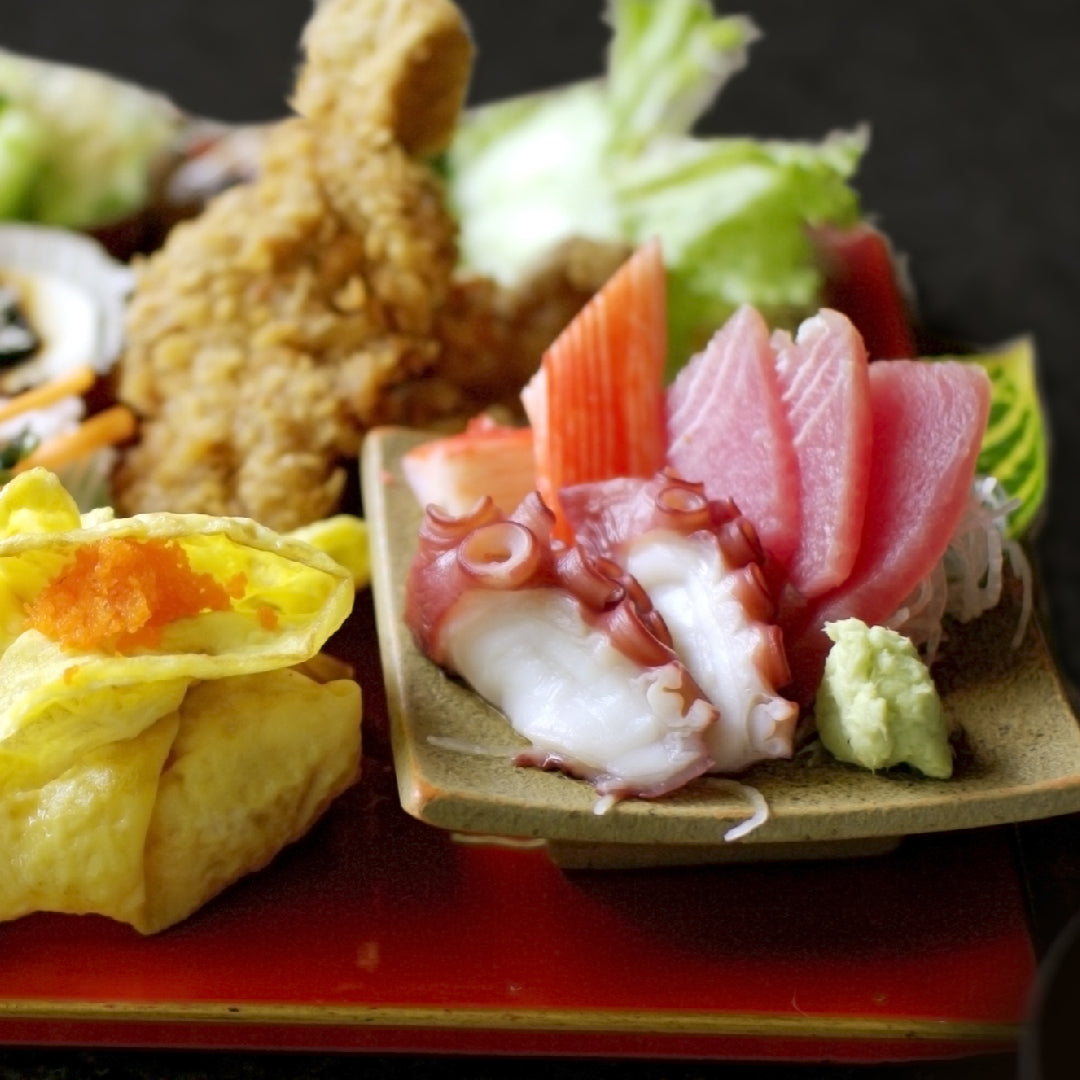 Elegant sushi platter with nigiri, sashimi, and specialty rolls arranged on a wooden board at a Portland Japanese restaurant