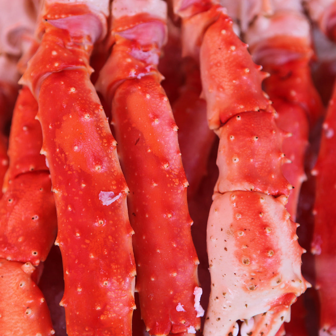 Premium king crab legs presented as a gift with lemon, butter, and elegant seafood packaging