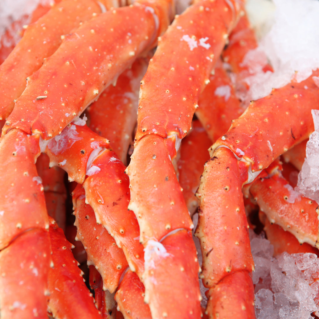Bulk king crab legs on ice ready for wholesale purchase, showcasing premium Alaskan seafood