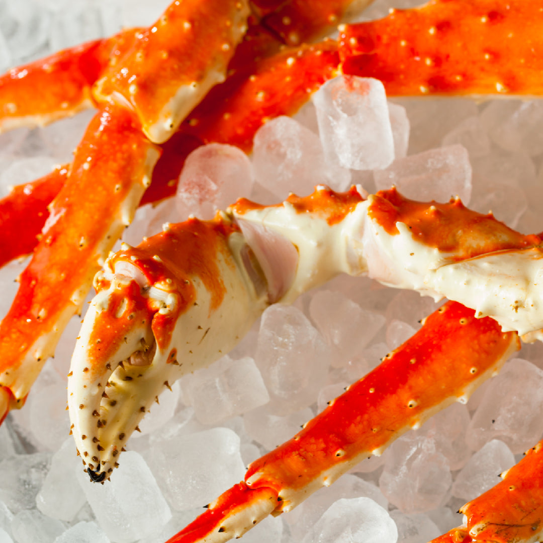 Jumbo Alaskan red king crab legs on ice ready for delivery