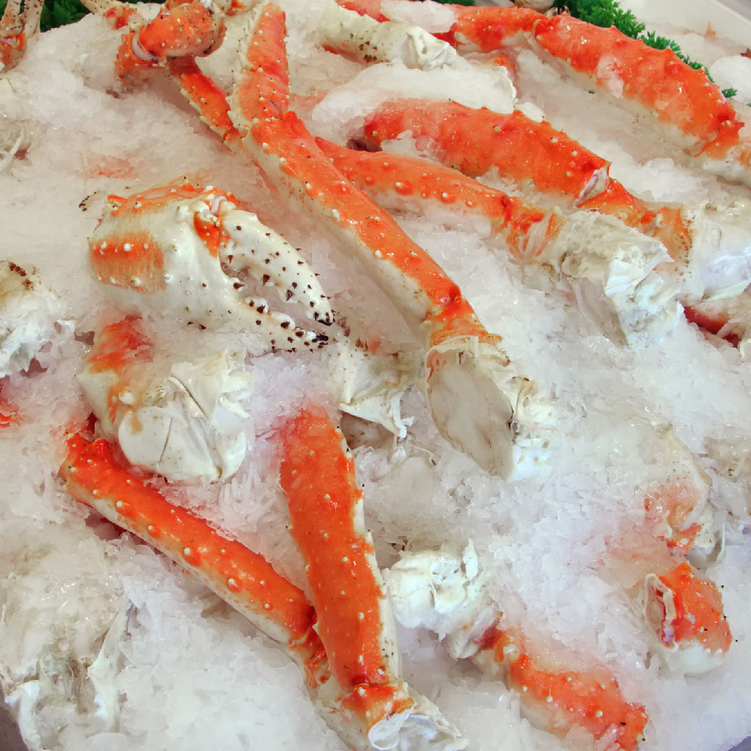 Fresh king crab legs salad with mixed greens, avocado, cherry tomatoes, and lemon dressing