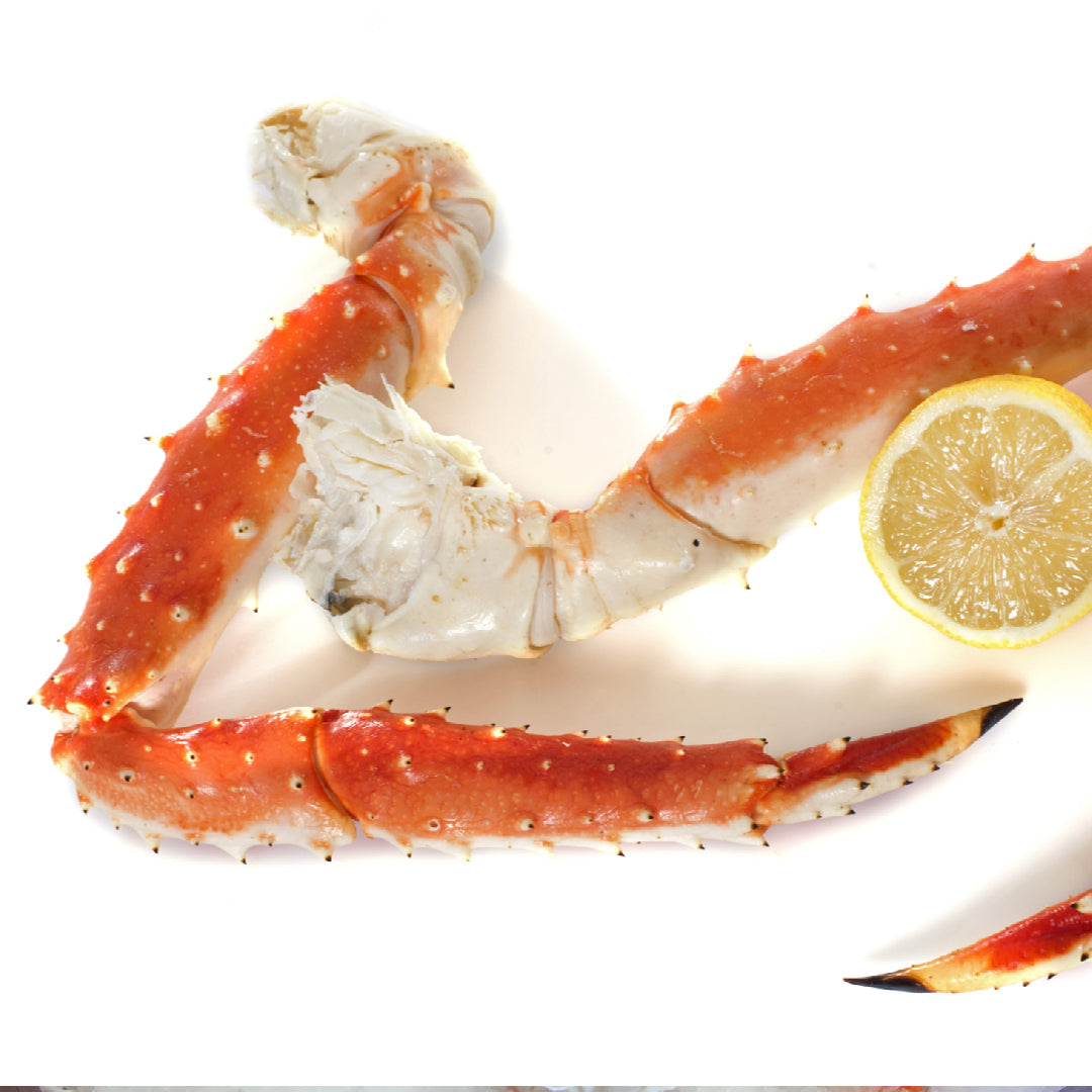 Frozen king crab legs thawing in a bowl of cold water