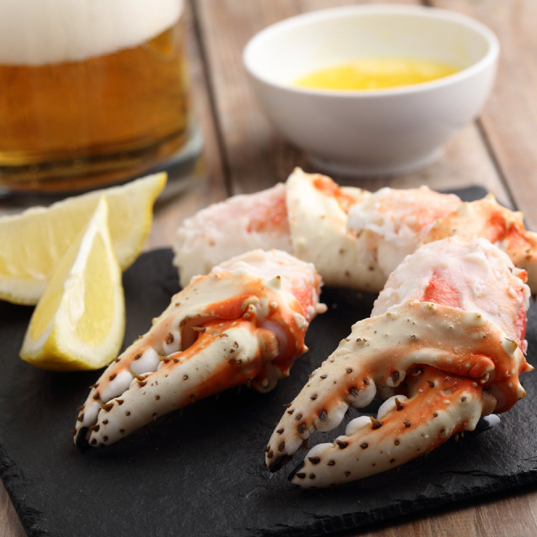 Fresh king crab legs displayed at a local seafood market counter with ice and price labels
