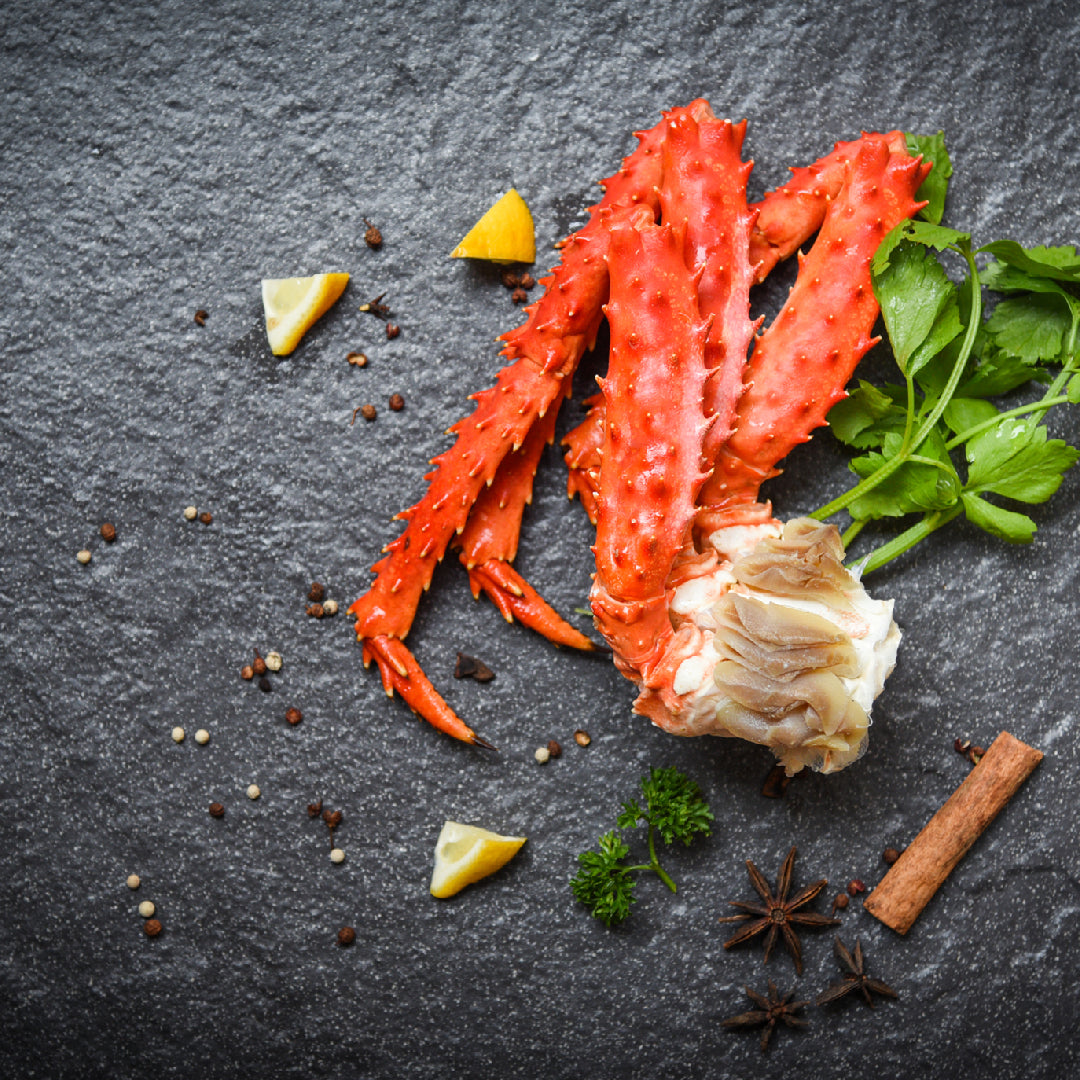 King crab legs being steamed in a large pot — the best method for reheating frozen king crab legs to preserve the sweet, rich flavor and moist texture of the meat