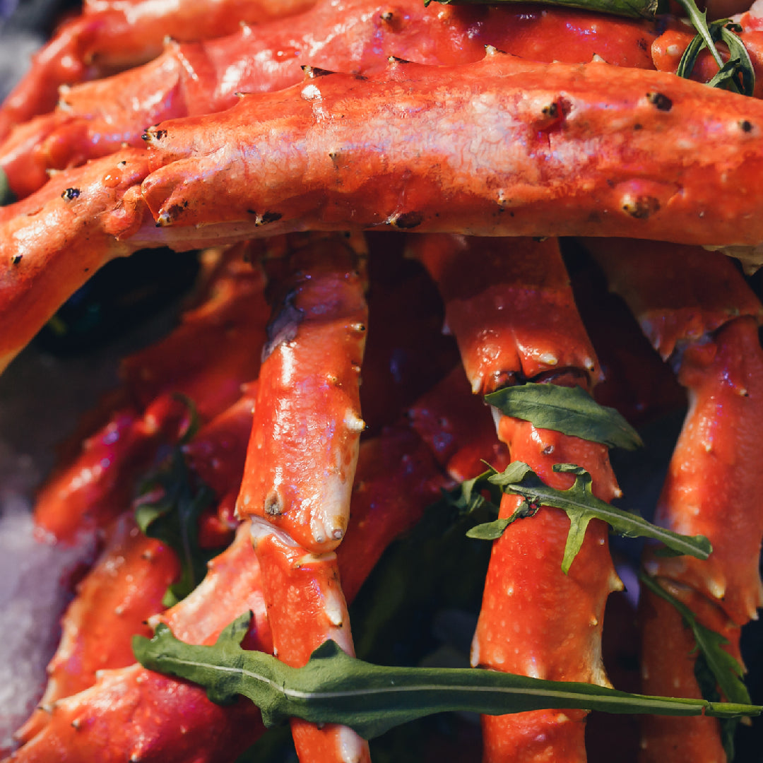 King crab legs and jumbo shrimp served together in garlic butter with lemon wedges