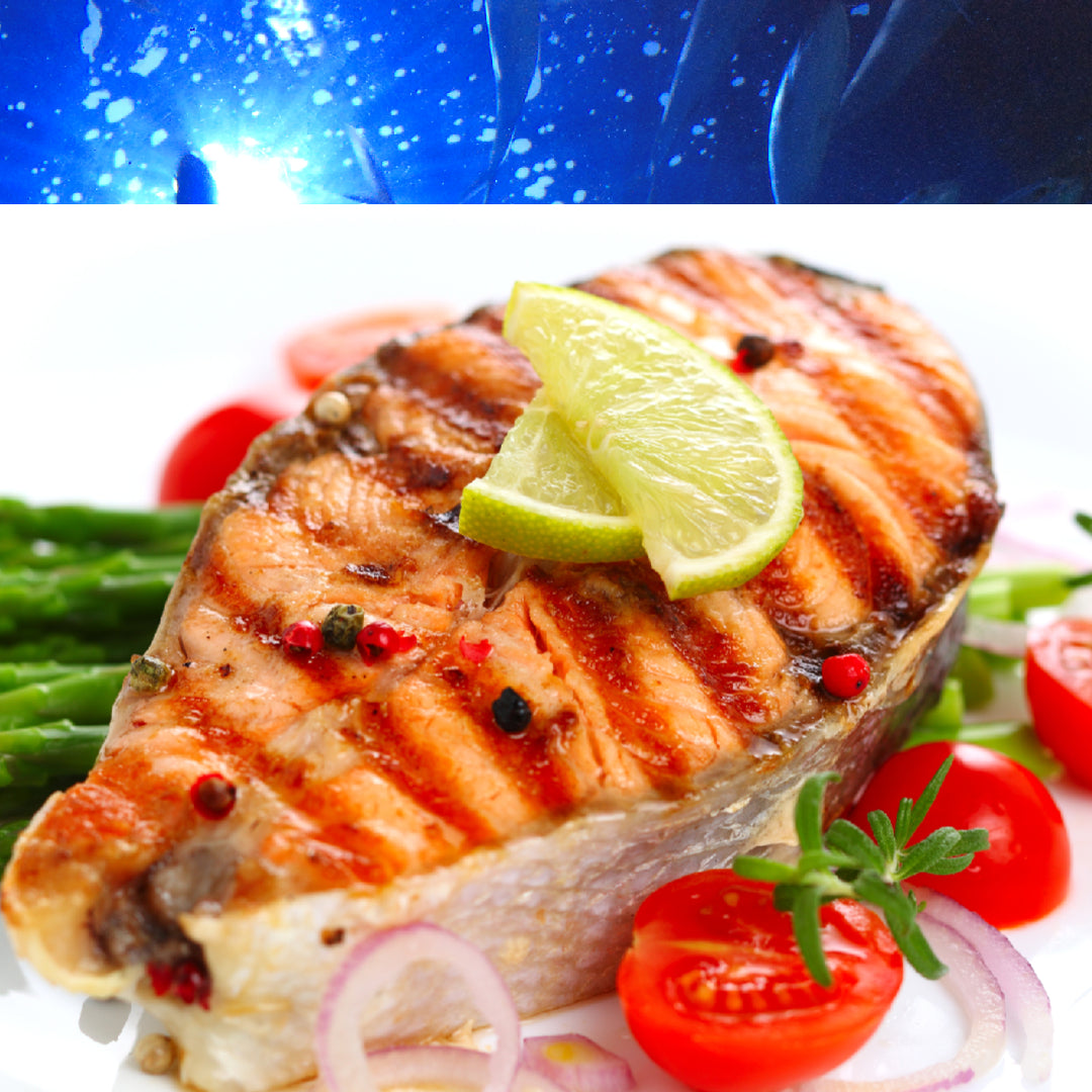Ten different King Salmon dishes including grilled fillets, sashimi, chowder, and pasta arranged on a rustic wooden table with fresh herbs and lemon