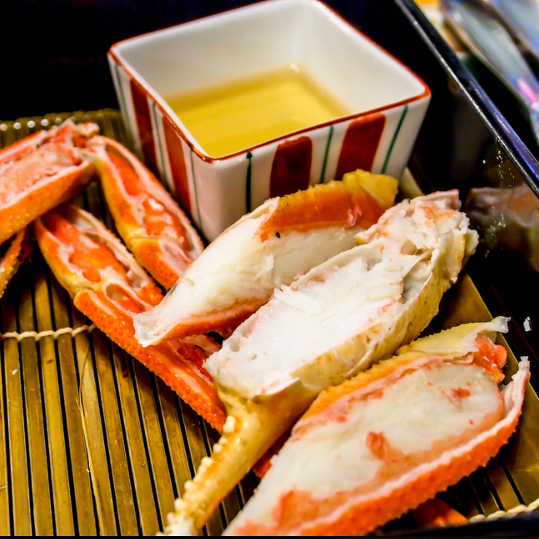 Frozen snow crab legs being steamed in a pot with lemon and butter