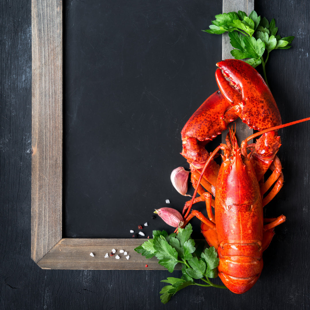 Fresh live lobsters in a tank at a seafood market ready for sale