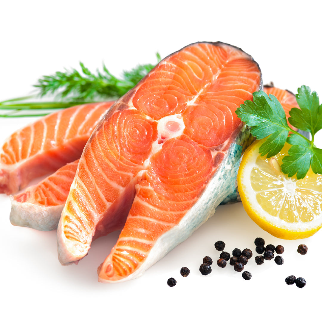 Beautifully plated Ora King Salmon fillet with vibrant orange marbling on a white restaurant plate