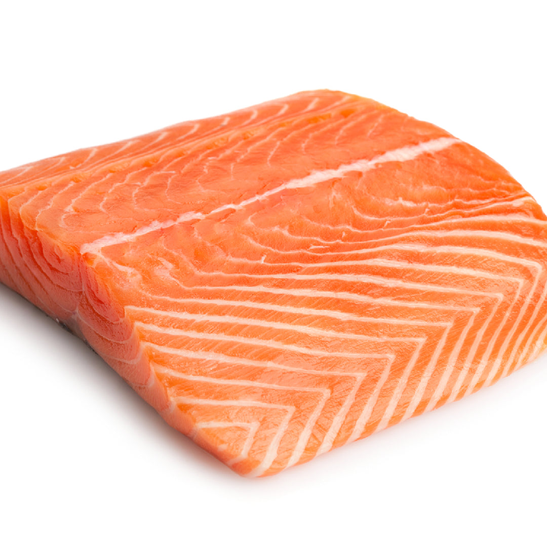 Assortment of Ora King Salmon dishes including sashimi, grilled fillets, and poke bowls on a restaurant table