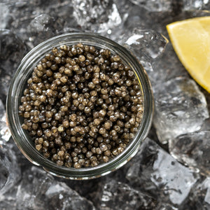 Assorted types of Osetra caviar displayed on ice, highlighting the range from golden to dark brown, symbolizing the variety and luxury of this gourmet delicacy