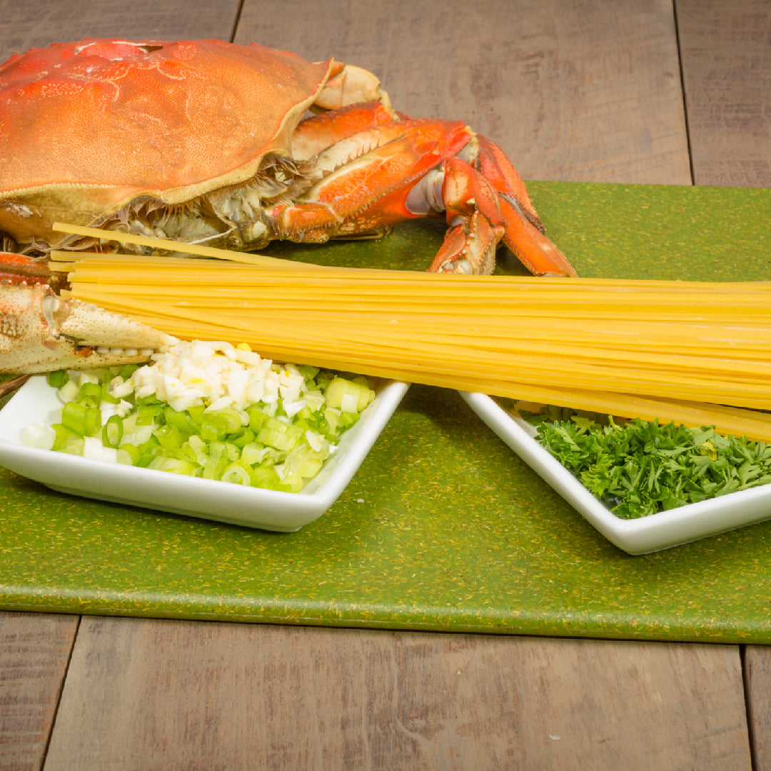 Plate of Dungeness crab linguine with garlic butter sauce and fresh parsley