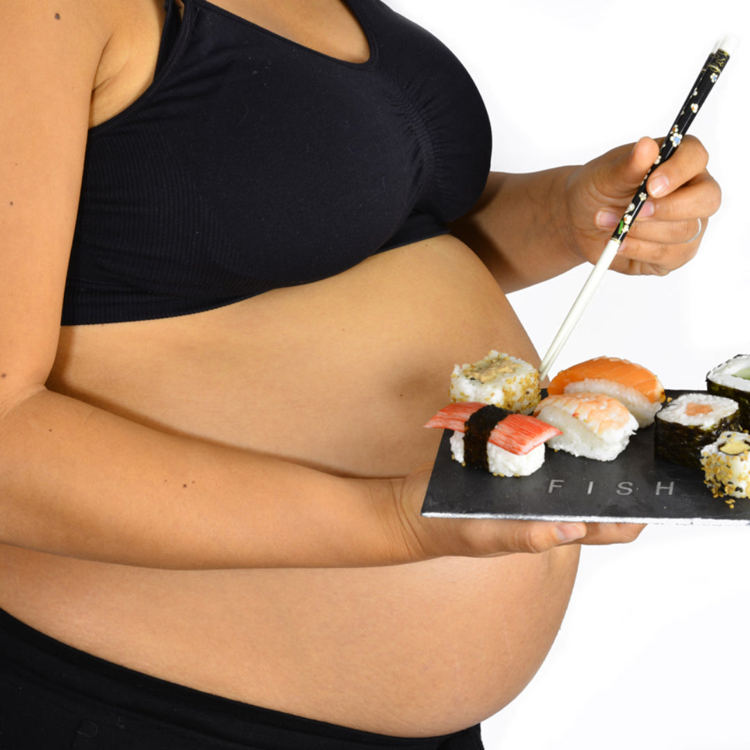 Pregnant woman holding a plate of crab legs