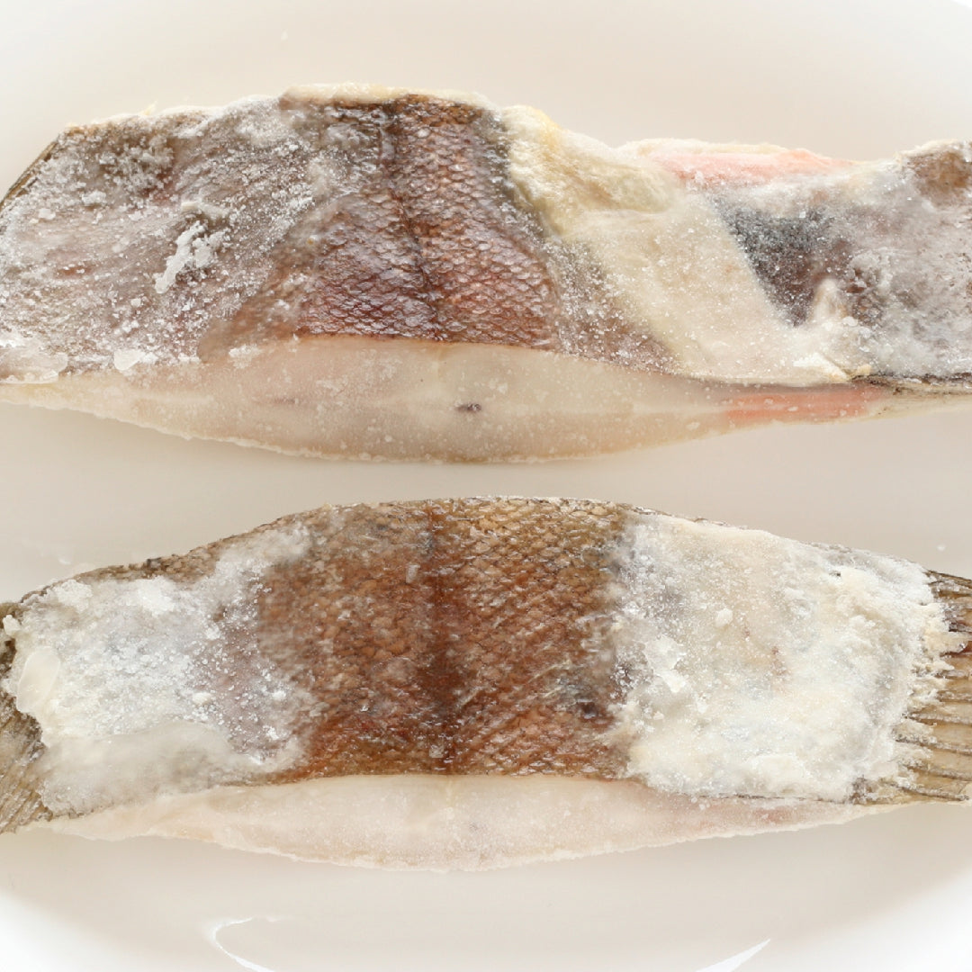 Fresh Petrale sole fillet on a plate with umami-rich ingredients like soy sauce and mushrooms