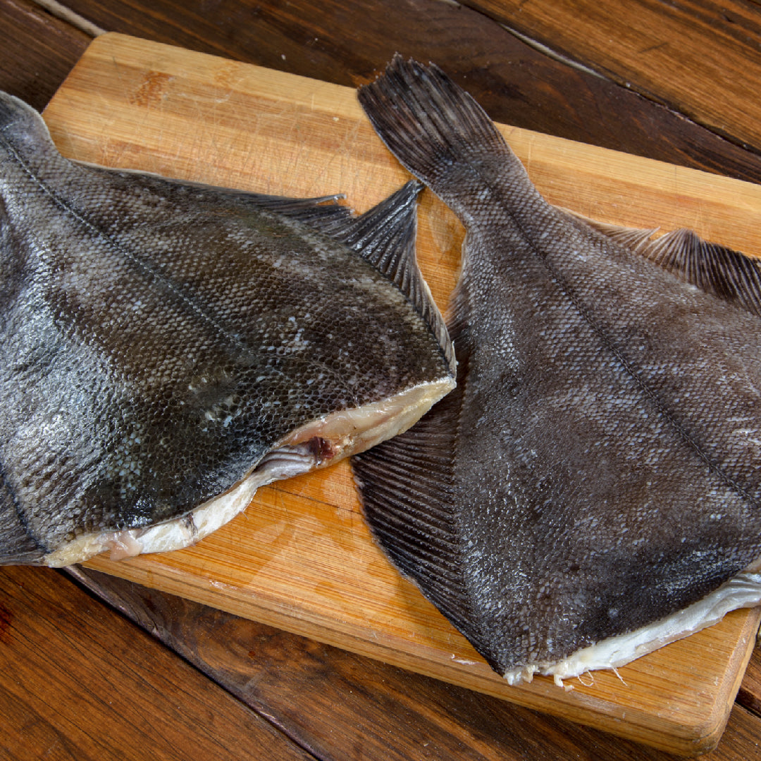 Vacuum-sealed frozen Petrale sole fillets with ice crystals, ready for storage