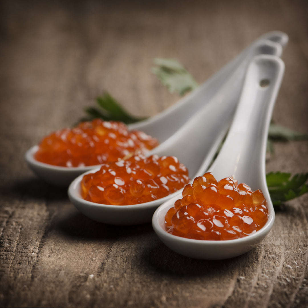 Salmon roe ikura served on blinis with crème fraîche and fresh dill