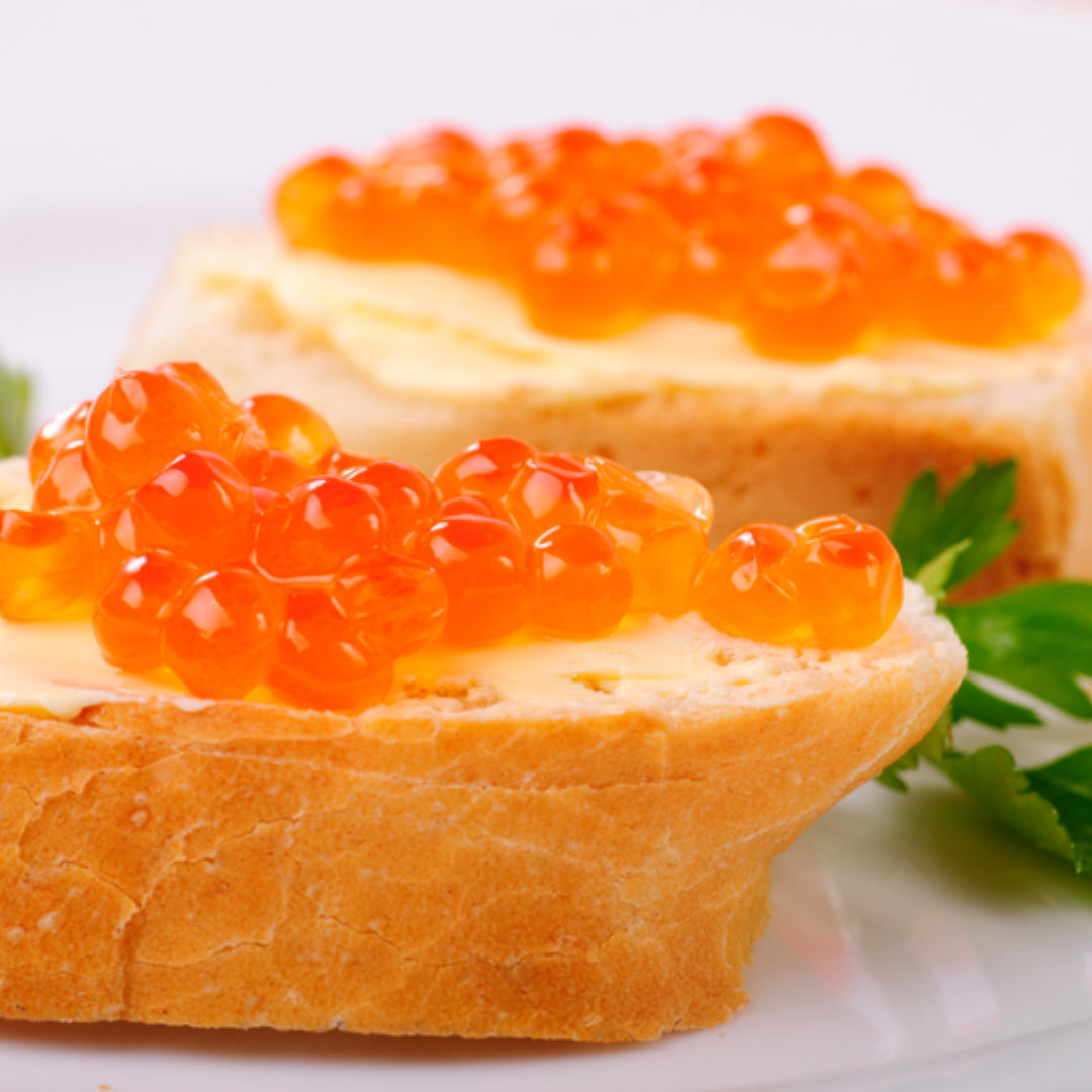 Close-up of fresh salmon roe (ikura) showing vibrant orange eggs rich in omega-3 fatty acids, astaxanthin, and essential vitamins and minerals