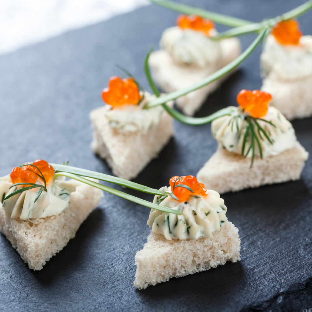 Elegant Red Caviar and Cream Cheese Crostini on a serving plate, garnished with fresh dill, ready to be served at a sophisticated gathering