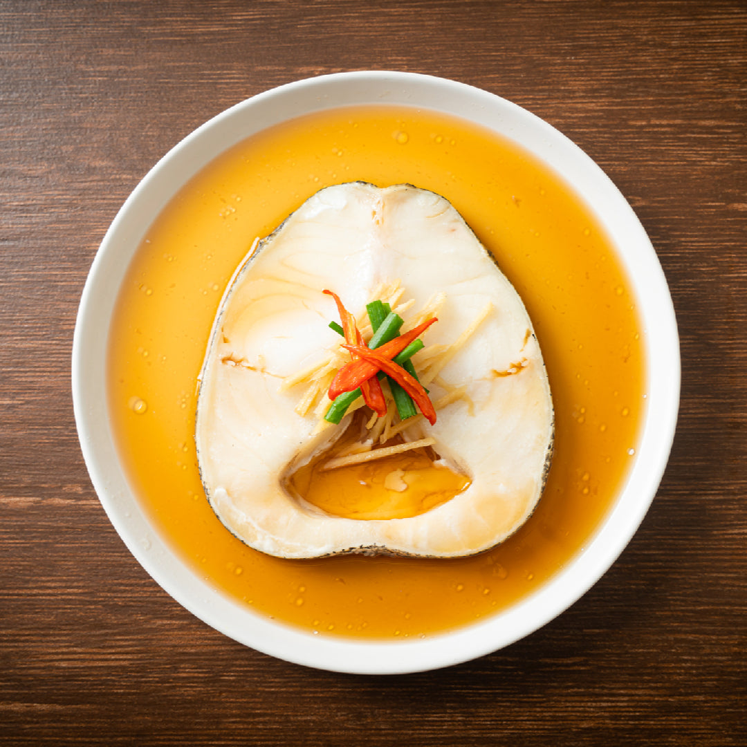 Pan-seared sablefish fillet with golden crust, fresh thyme and lemon wedges on a white plate, demonstrating perfect beginner cooking technique