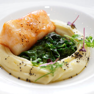 Healthy sablefish (black cod) dish served with fresh vegetables, highlighting the fish's rich, buttery texture and its role in athletic nutrition and performance
