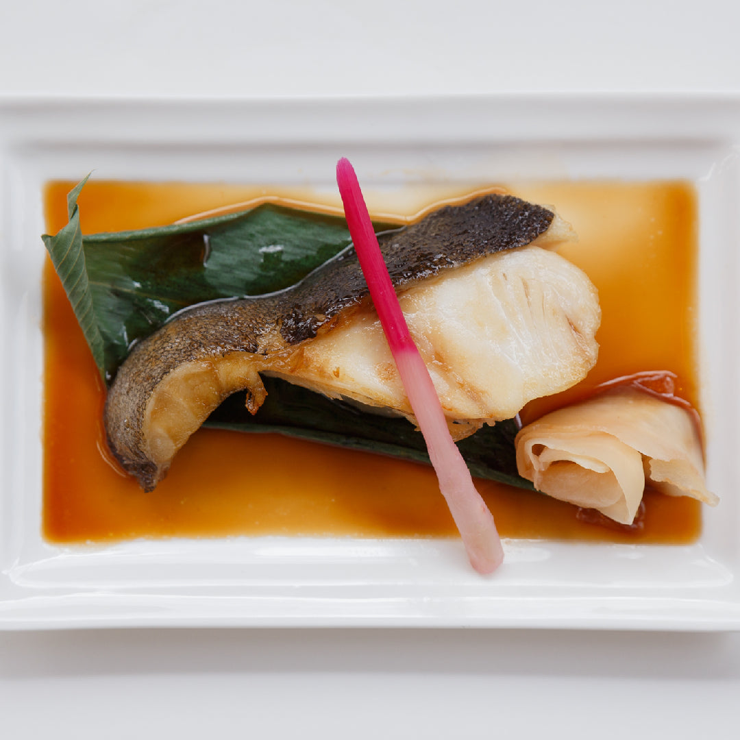 Fresh sablefish, also known as black cod, displayed on ice, showcasing its glossy, dark skin and premium quality, ready for culinary preparation