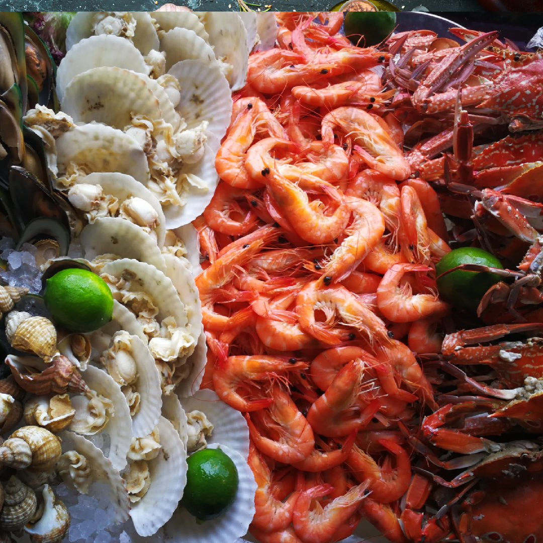 Gourmet seafood meal with lobster tail, shrimp scampi, and salmon fillet plated for home delivery