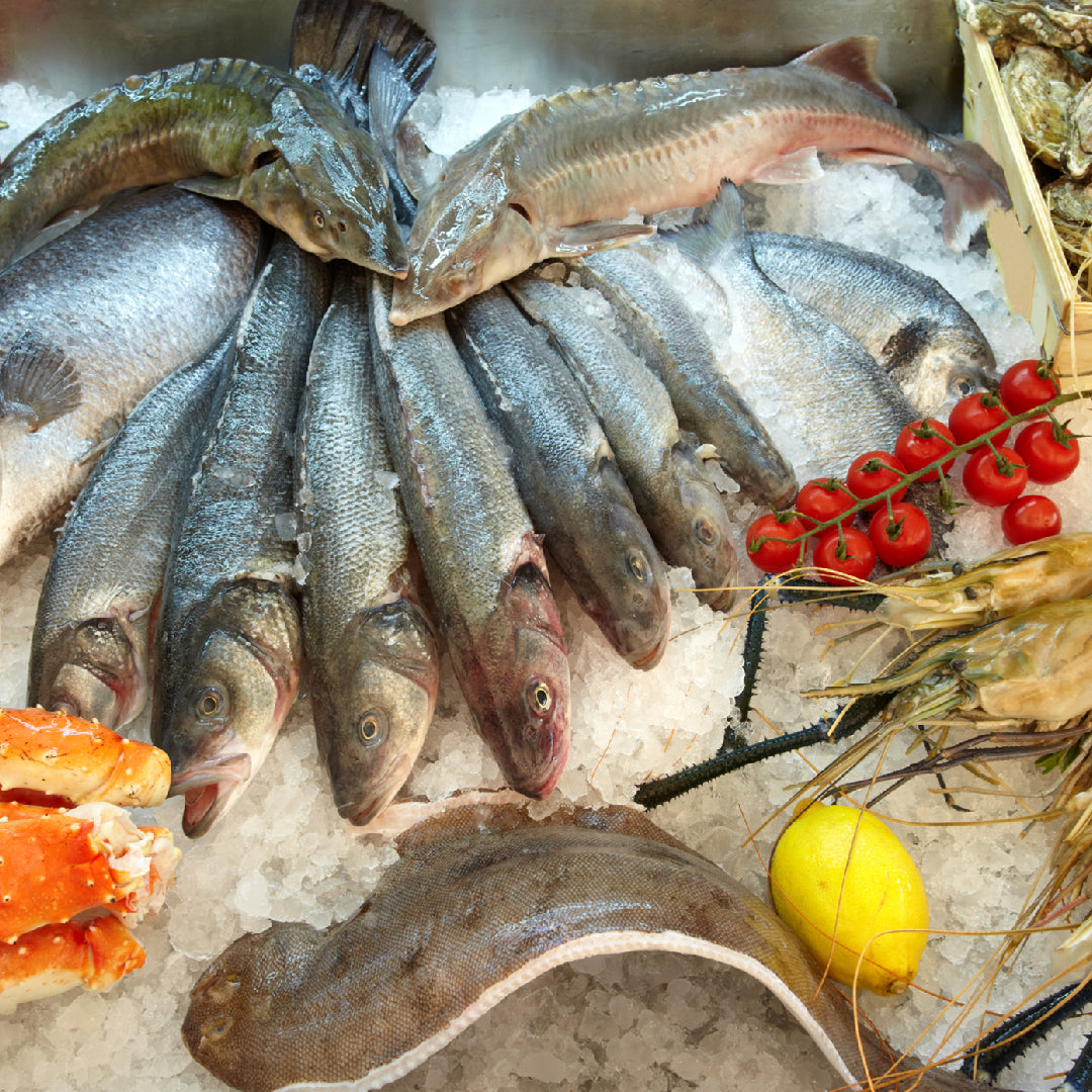 A beautifully arranged gourmet seafood gift basket featuring smoked salmon, lobster tails, caviar, crackers, and accompaniments — the ultimate luxury gift for seafood lovers
