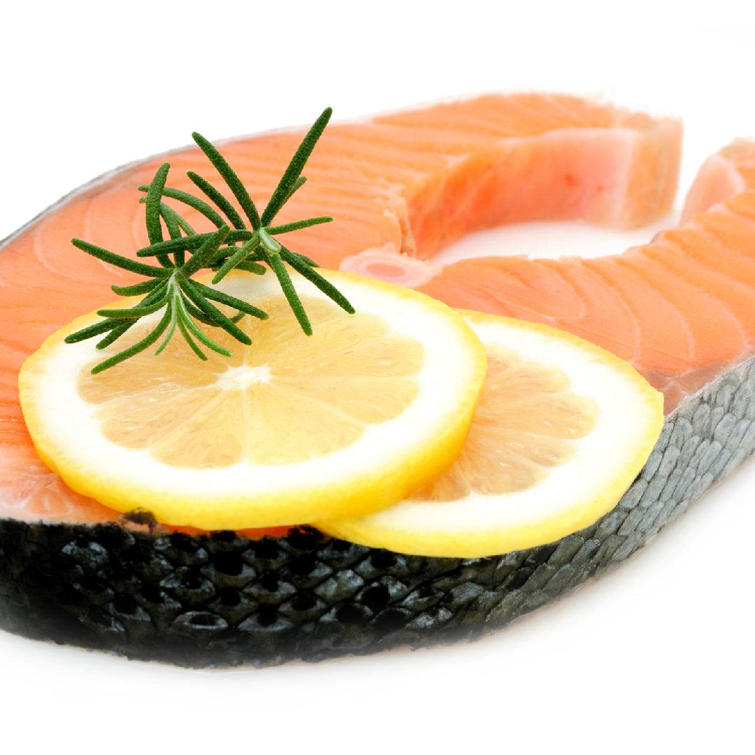 Silver salmon fillet served with roasted asparagus and quinoa salad on a white plate
