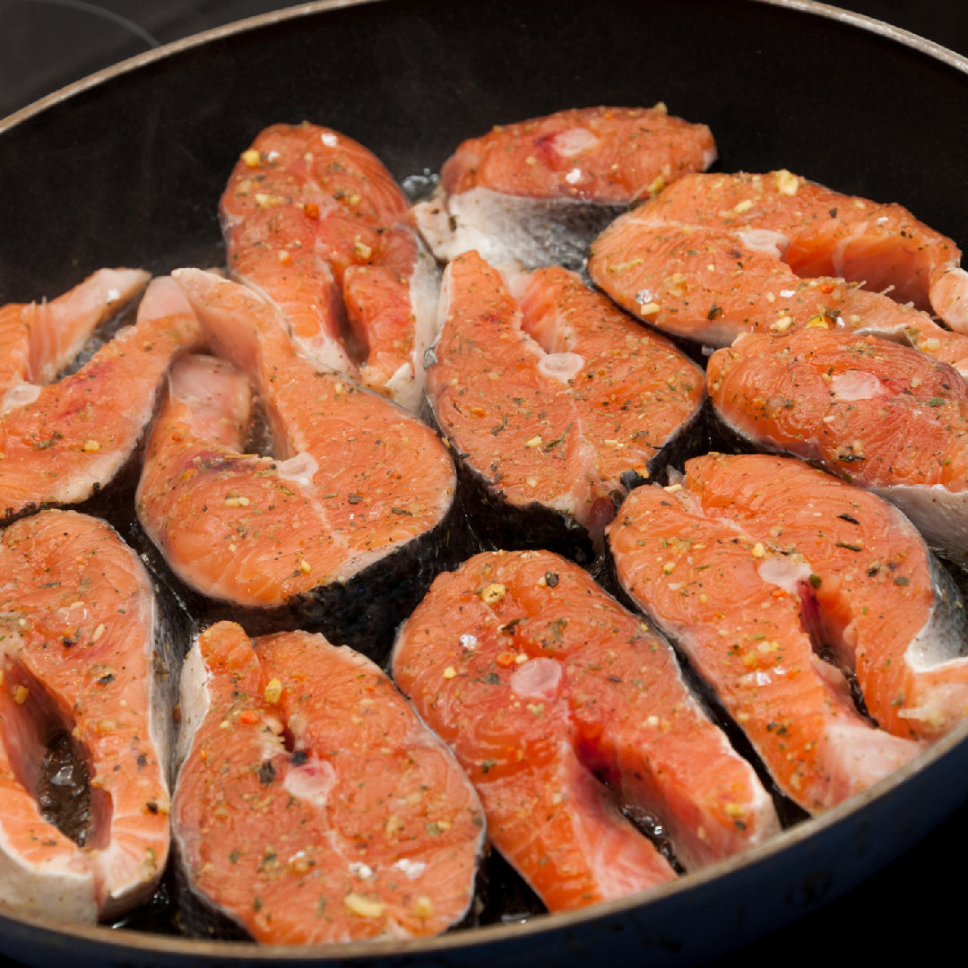 Fresh wild-caught silver salmon fillet on a wooden board