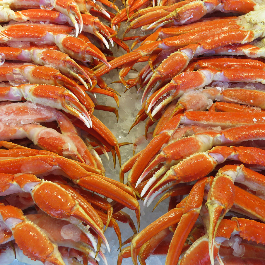 Grilled snow crab legs with garlic butter and lemon on a BBQ grill
