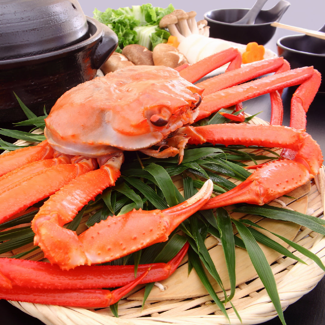 Fresh snow crab legs served on a platter with lemon wedges and dipping sauces