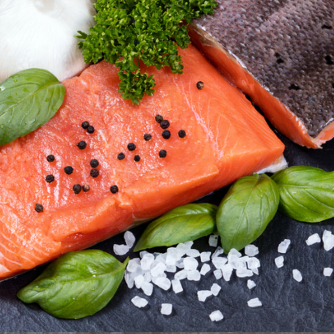 Salmon fillets portioned at 6 ounces each for a dinner party — the standard main course serving size for boneless salmon fillet per adult