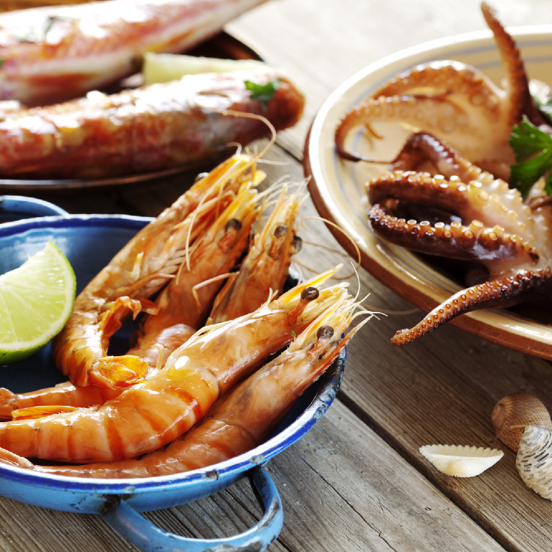 Fresh wild-caught salmon, lobster, and whitefish displayed on ice at an online seafood market