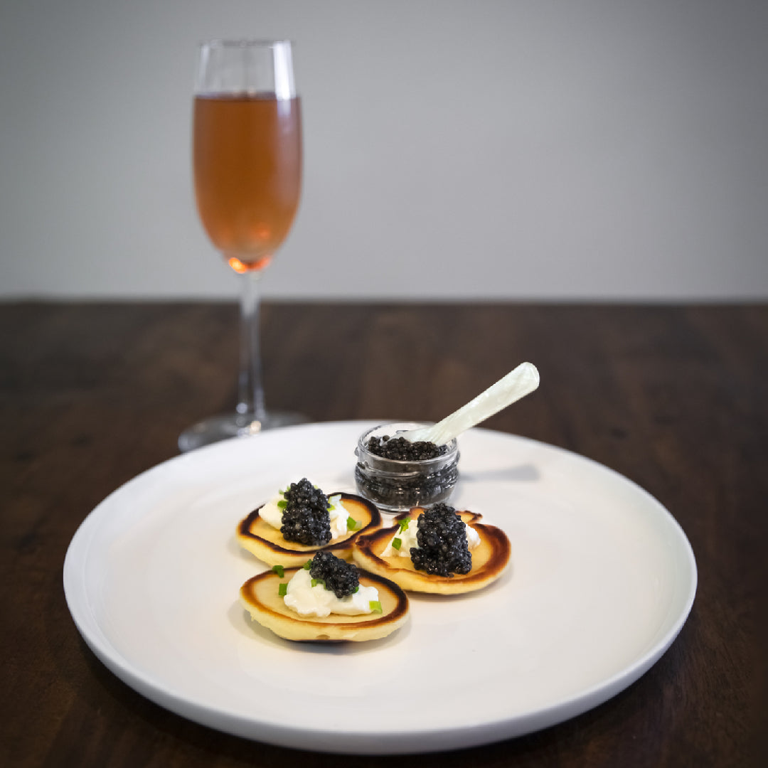 Global sturgeon caviar market growth chart alongside premium caviar tins and a world map highlighting key producing regions