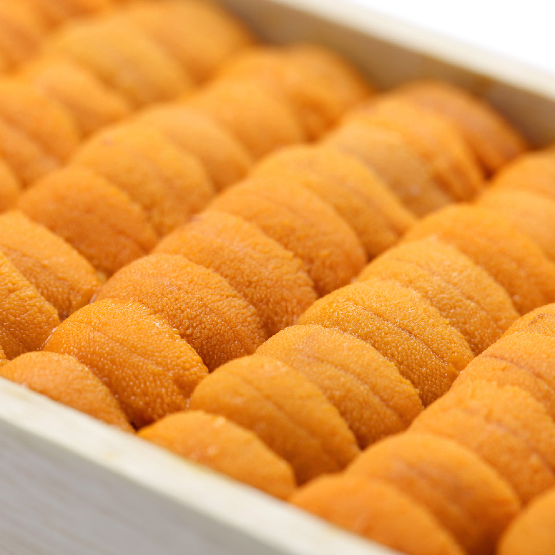 Fresh golden uni sea urchin on a wooden tray ready for sushi