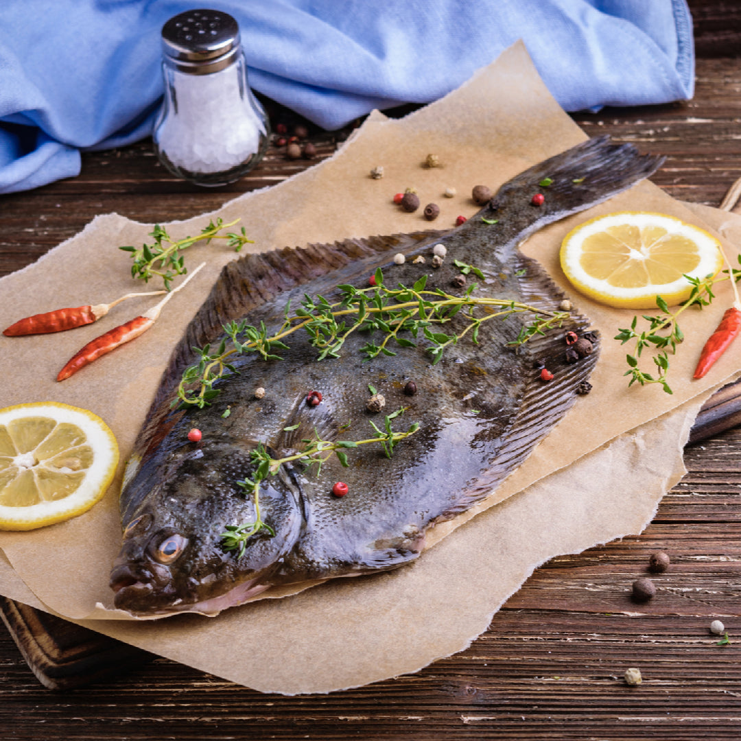 Elegant Petrale sole fillet with lemon butter sauce plated for a romantic dinner at home